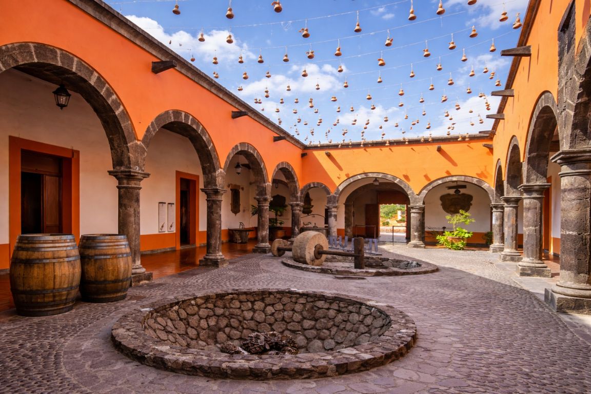 Museo Nacional del Tequila courtyard with traditional arches and agave roasting pit in Tequila town, visited during a guided tour with Guadalajara Tequila Tours