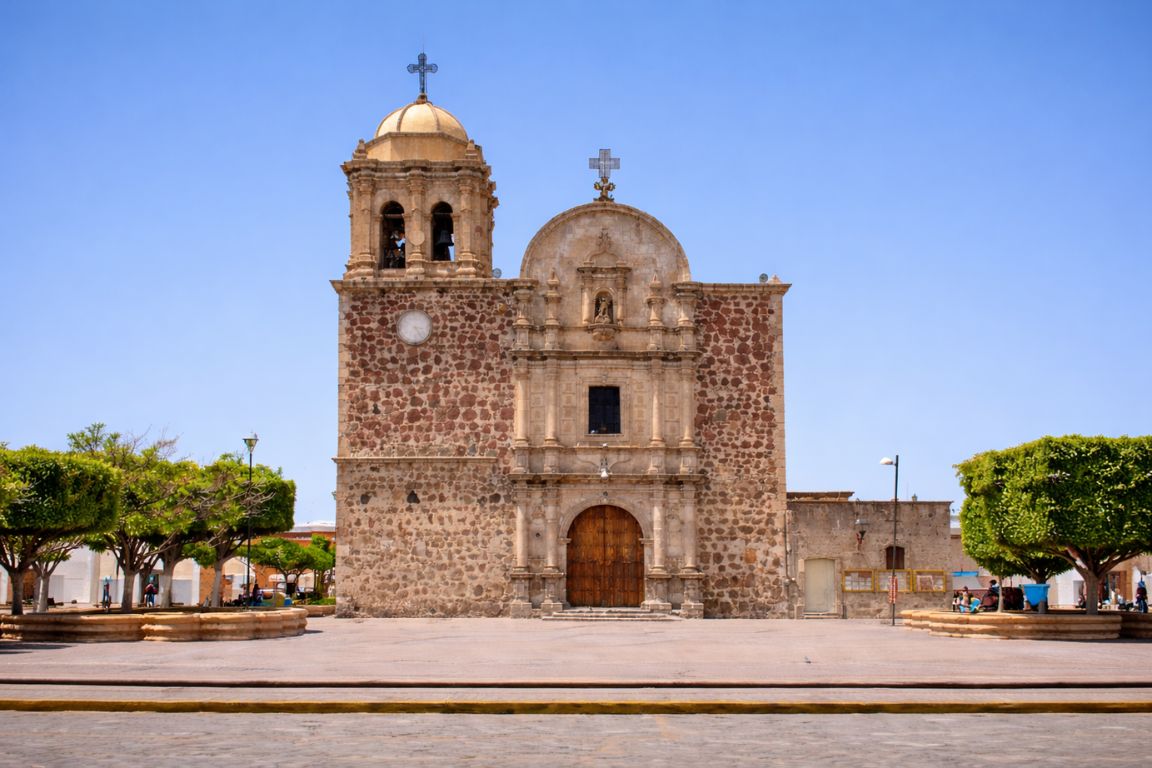 Templo de la Purísima Concepción historic church in Tequila Jalisco with stone facade and bell tower, visited during a guided tour with Guadalajara Tequila Tours